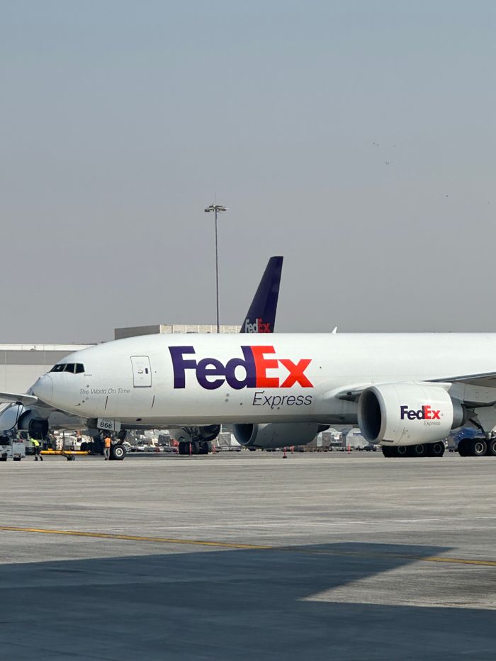 journey FedEx cargo aircraft parked at Dubai International Airport on a clear day.